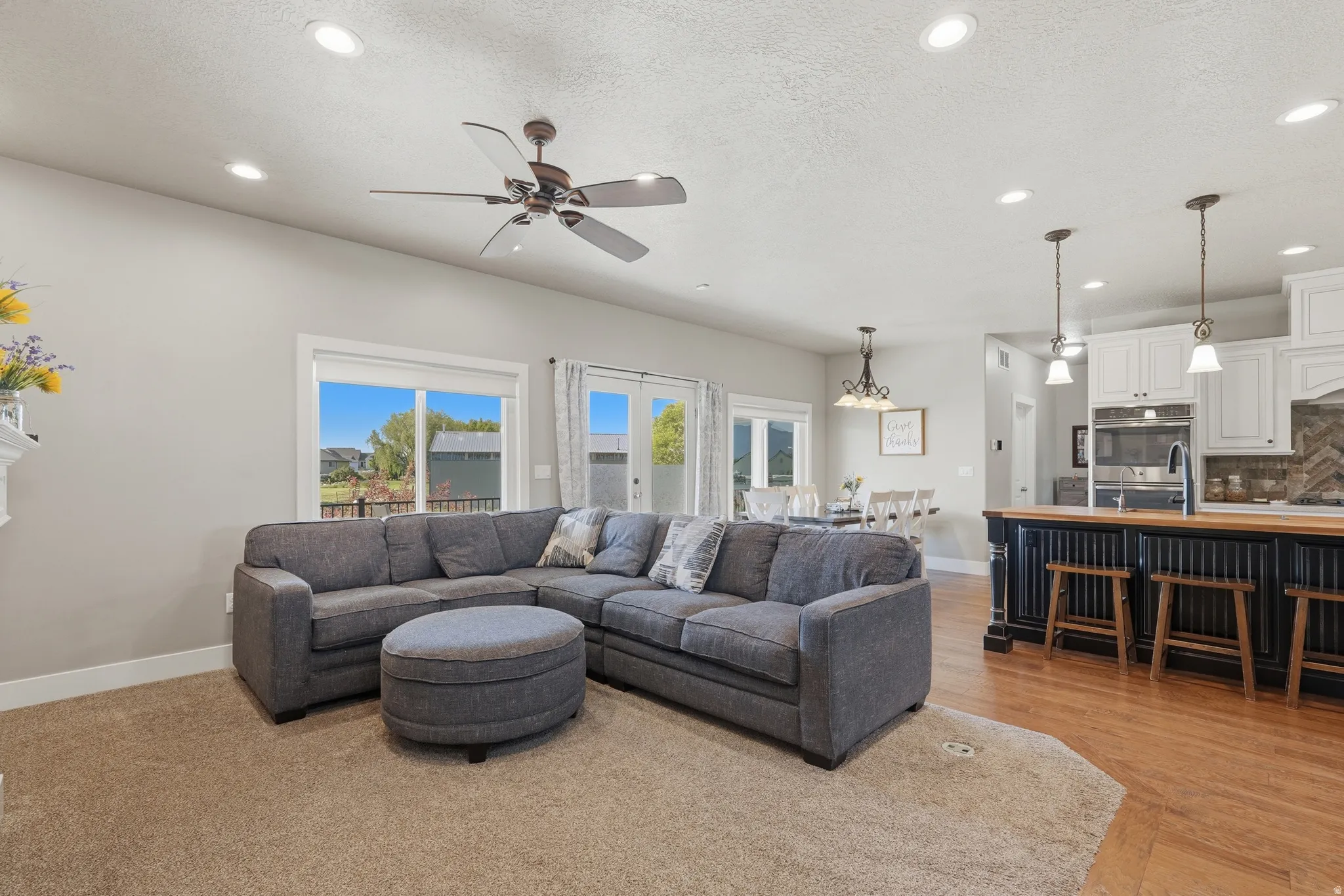 Open concept living area featuring recessed lighting and a ceiling fan
