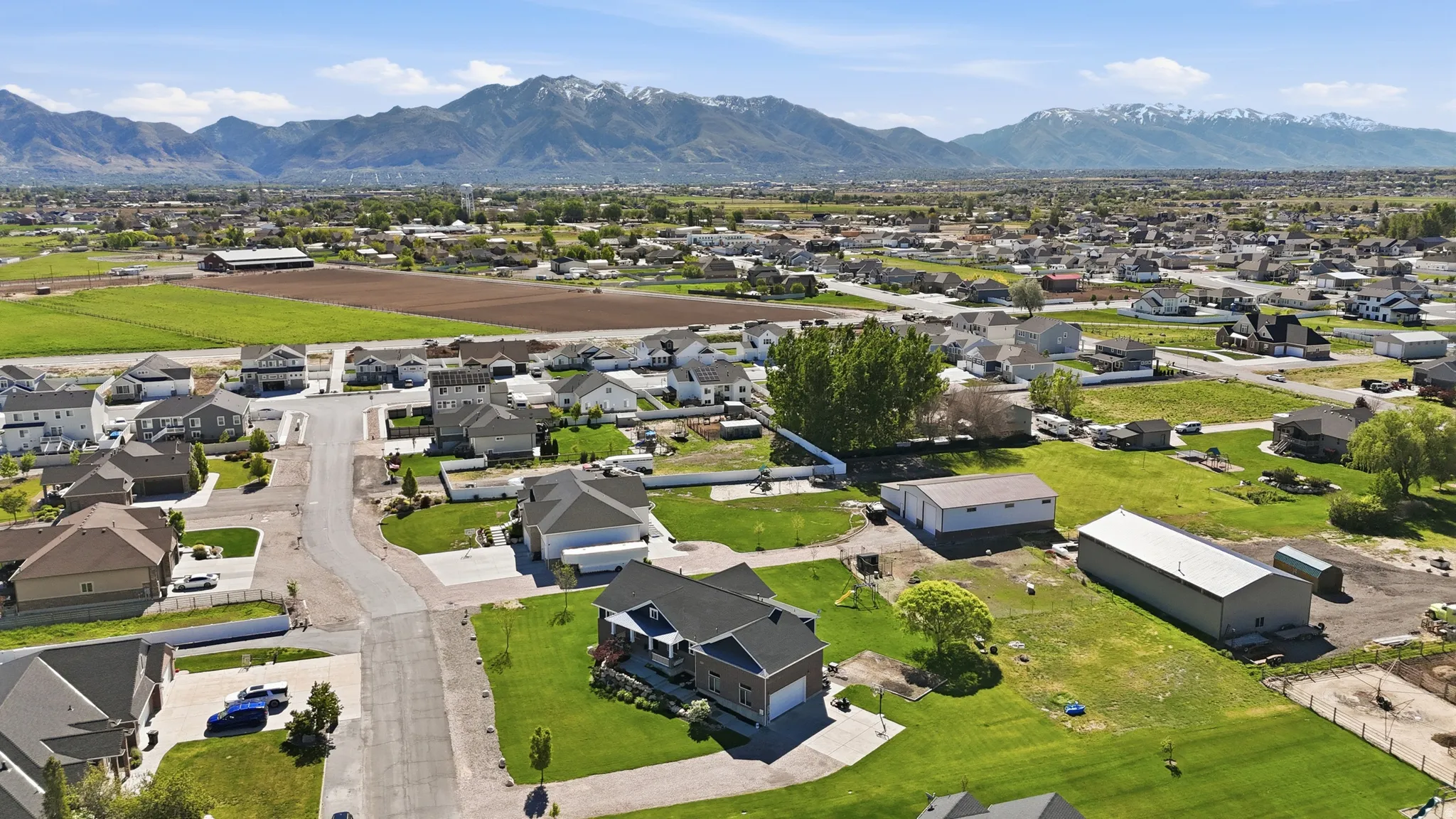 Expansive residential area featuring a mix of single-family homes, mature trees, and a distant mountain backdrop