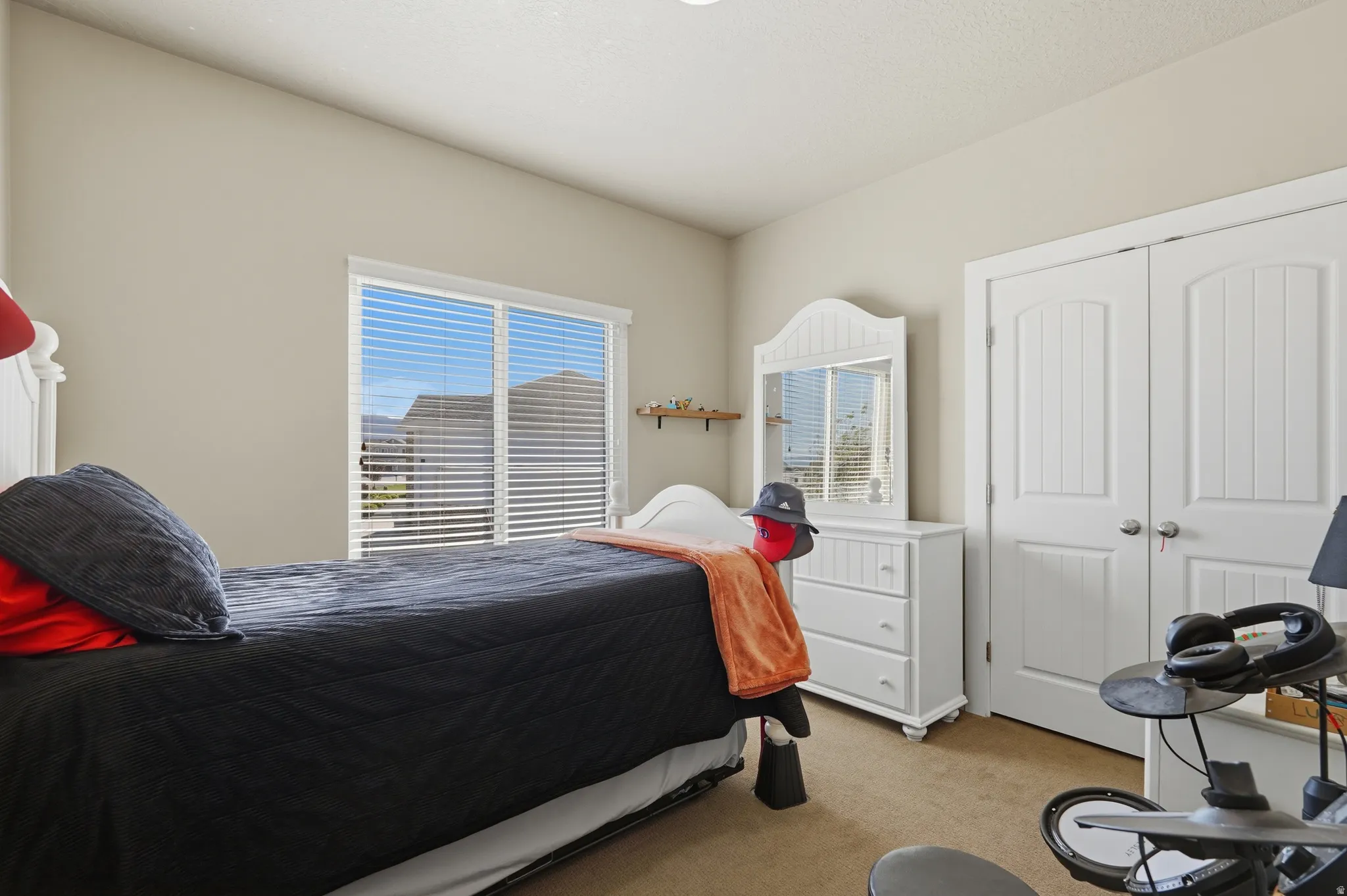 Room with neutral wall paint and carpeted flooring
