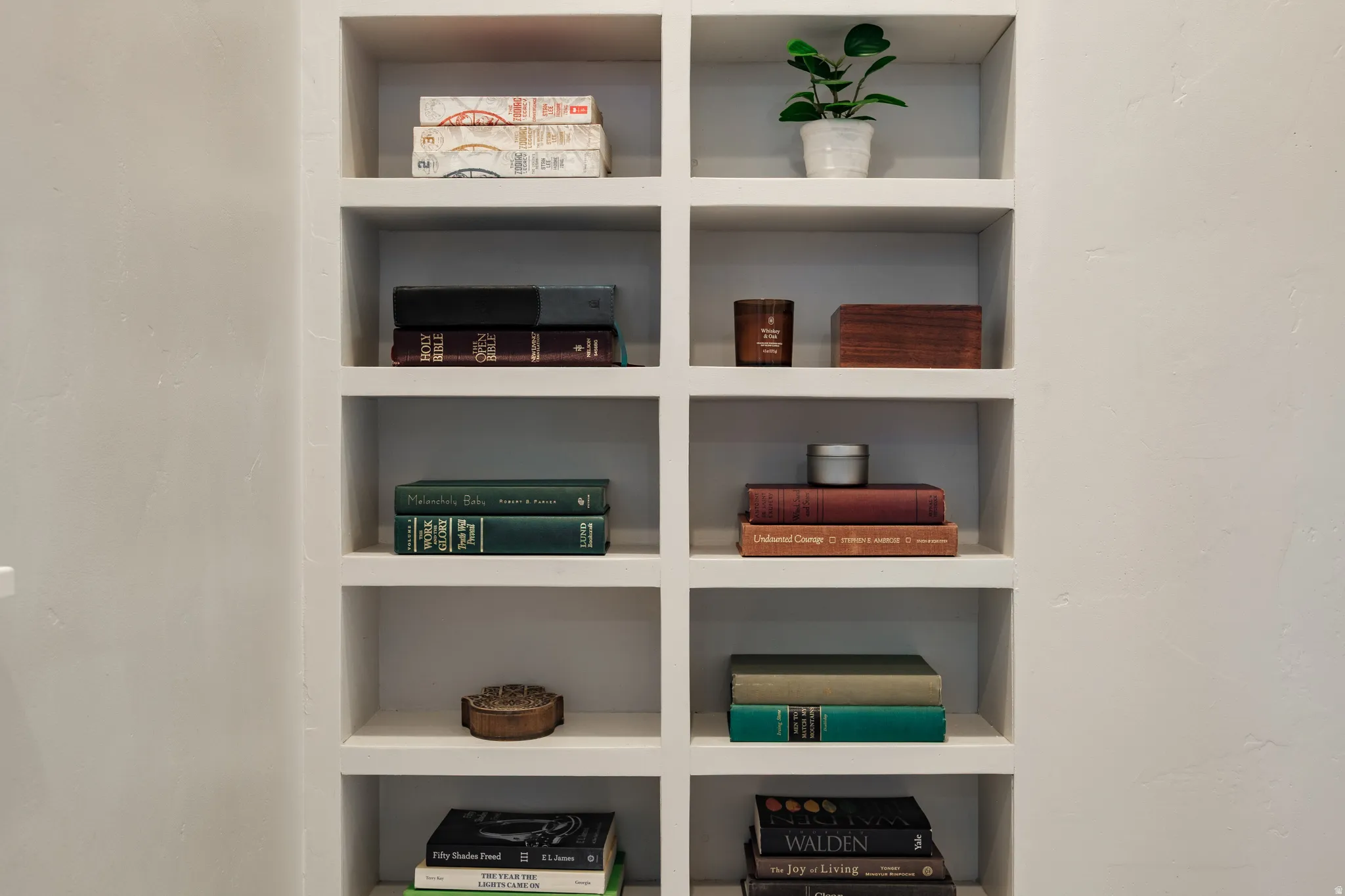 Built-in shelving unit featuring multiple recessed compartments, a smooth painted finish, and integrated wall construction
