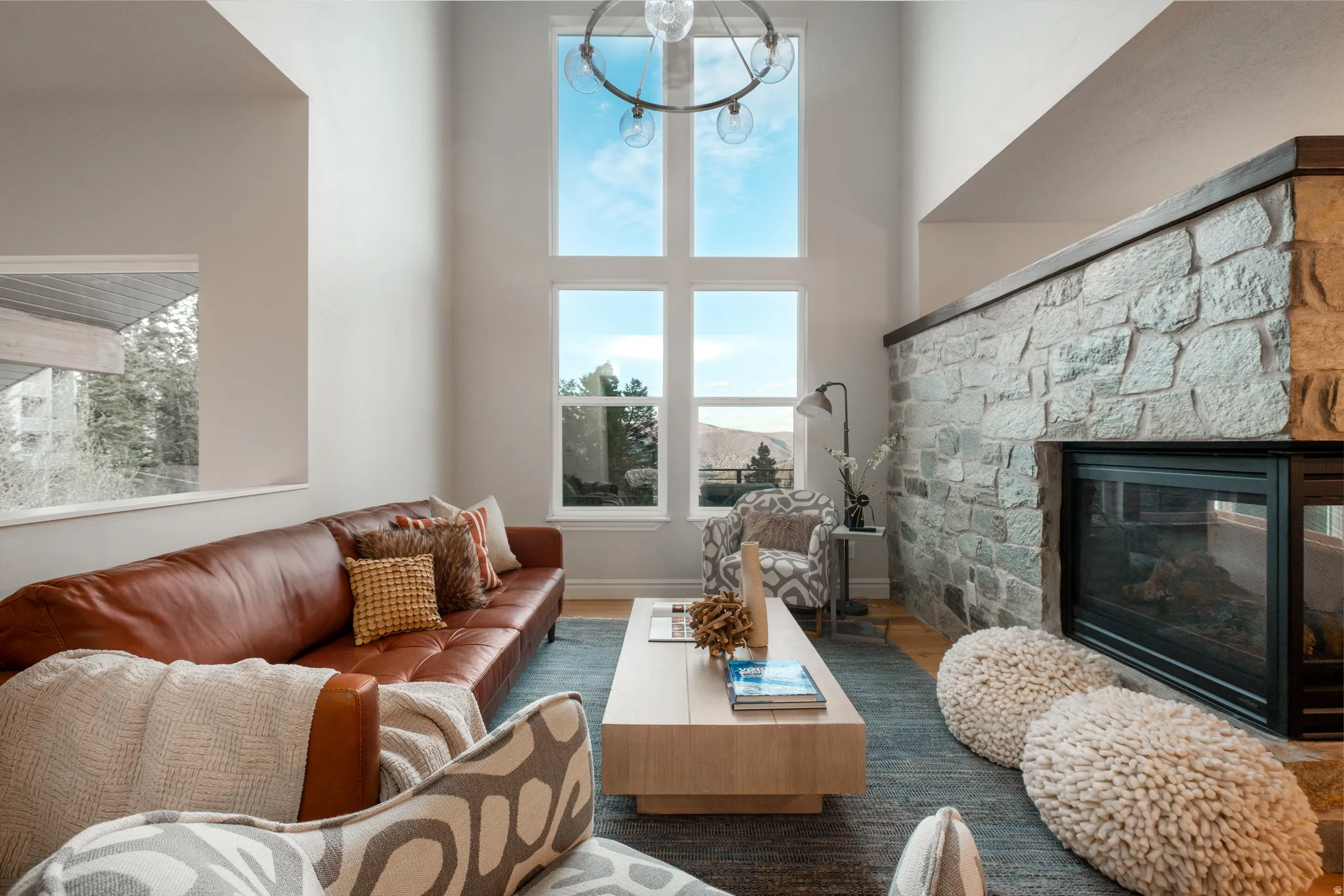 High vaulted ceilings with a contemporary chandelier and expansive windows