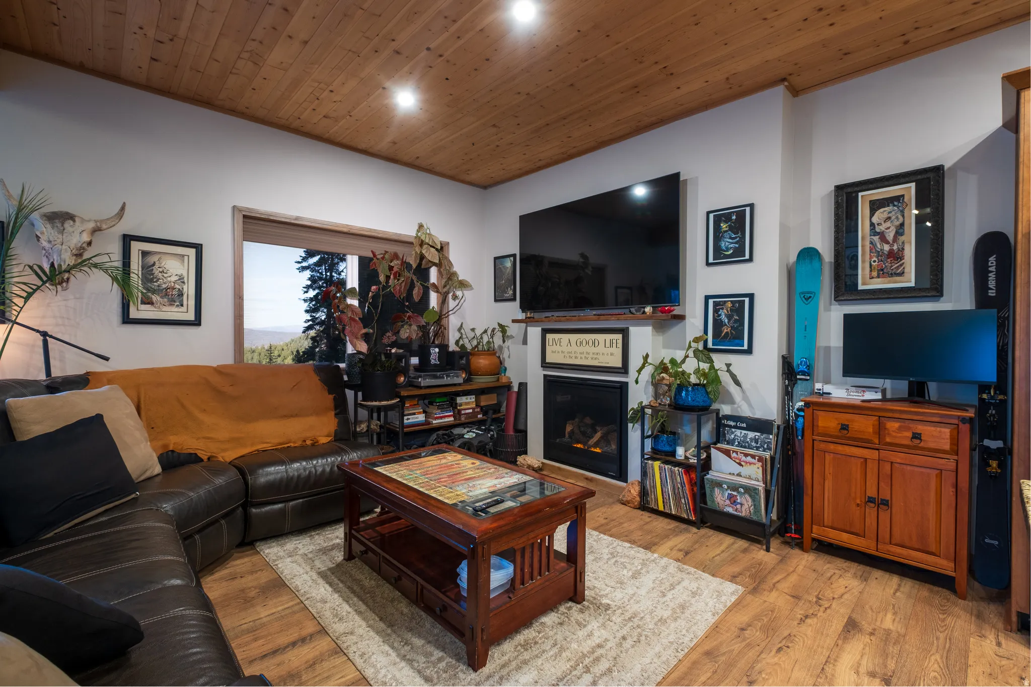 Living area featuring wood-finish flooring and a wood plank ceiling