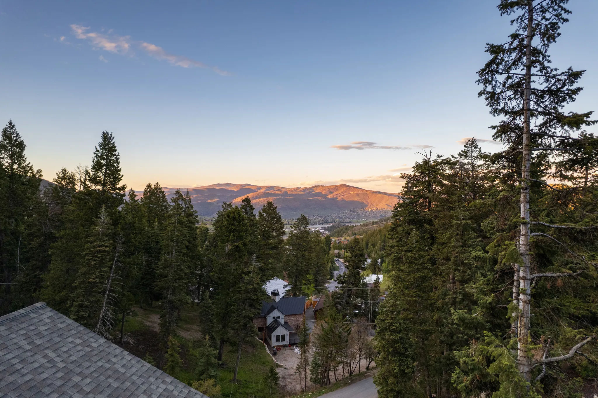 Expansive mountain scenery with a distant horizon and a dense forest canopy