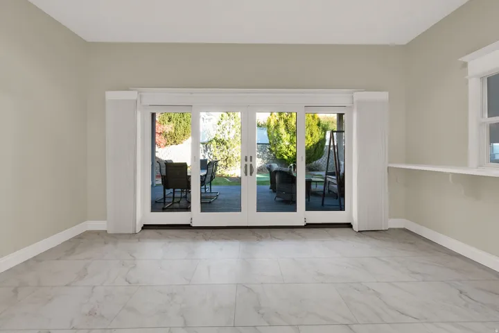 Sliding glass doors opening to the exterior patio