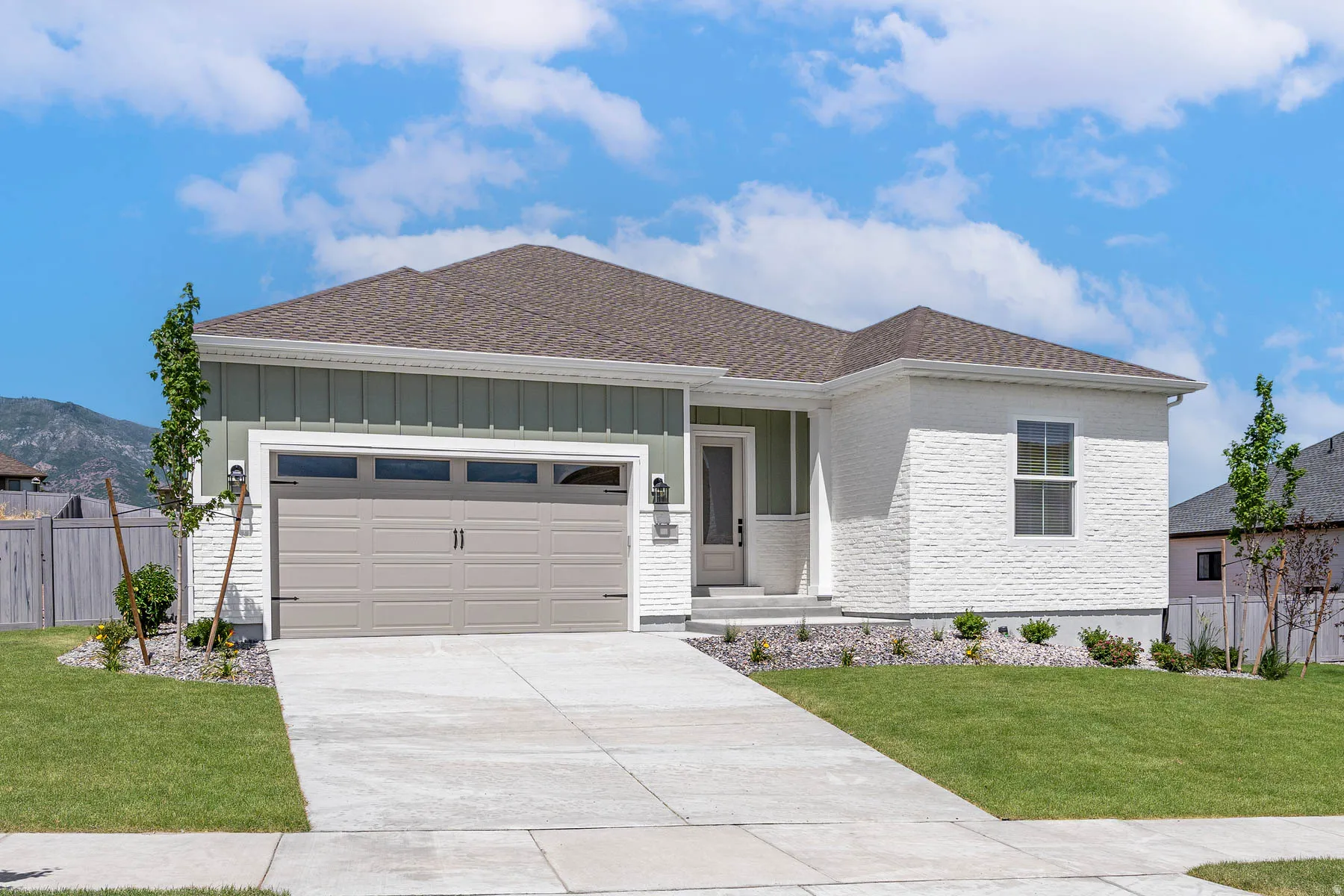 Contemporary exterior featuring a combination of light green vertical siding and white painted brick