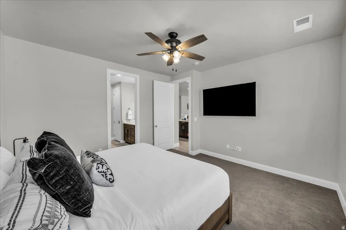 Spacious room featuring neutral wall tones and plush carpeting