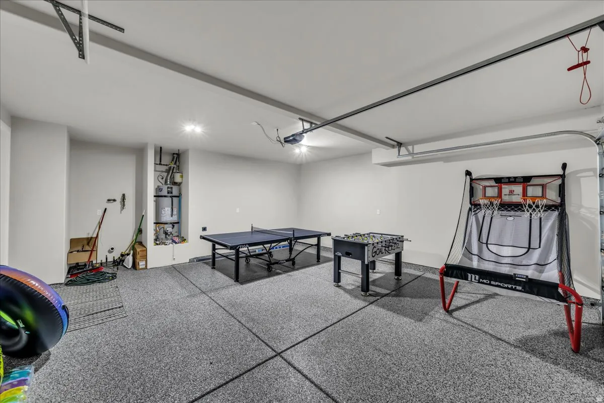 Spacious garage featuring a speckled epoxy floor, recessed lighting, and white walls