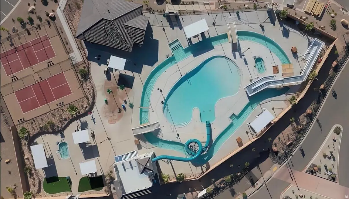 Expansive community aquatic center featuring a resort-style swimming pool, winding lazy river, and a water slide