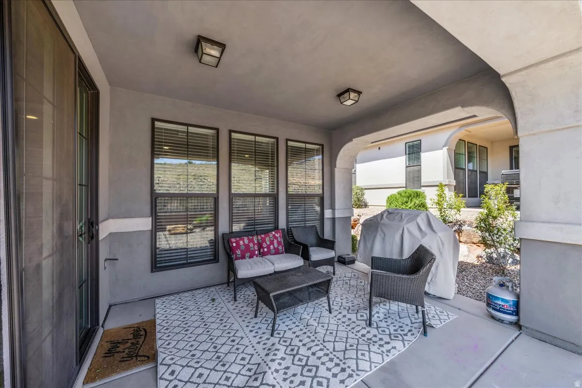 Covered patio featuring an arched entryway, recessed lighting, and direct access through a sliding glass door