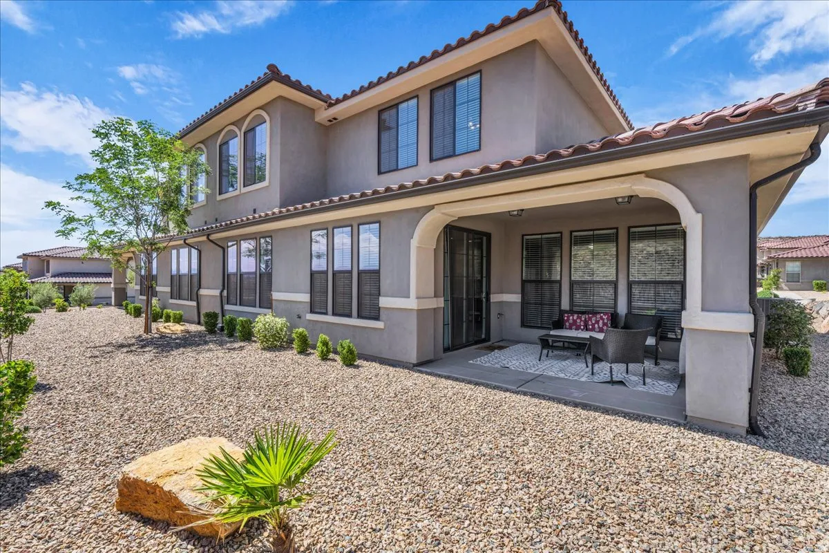 Stucco exterior with a terracotta tile roof and multiple windows