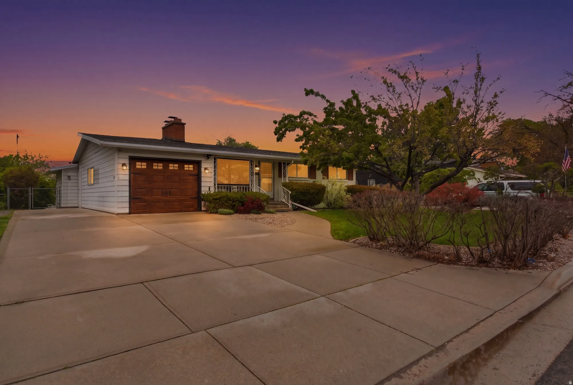 Ranch-style exterior with white horizontal siding and a dark roof