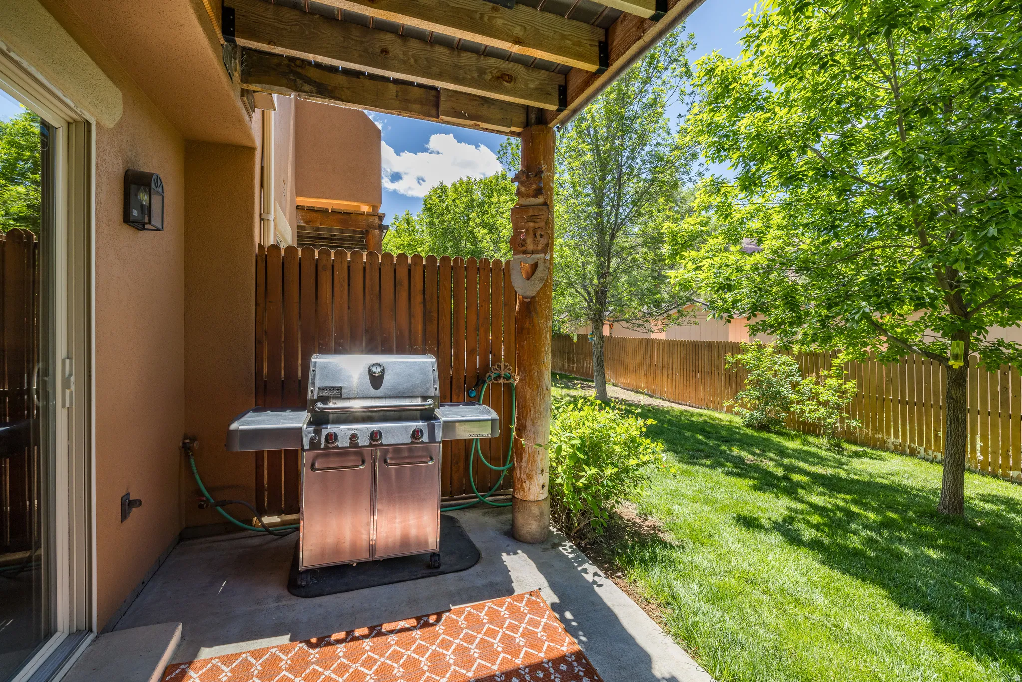Covered patio featuring a concrete slab and wood beam ceiling