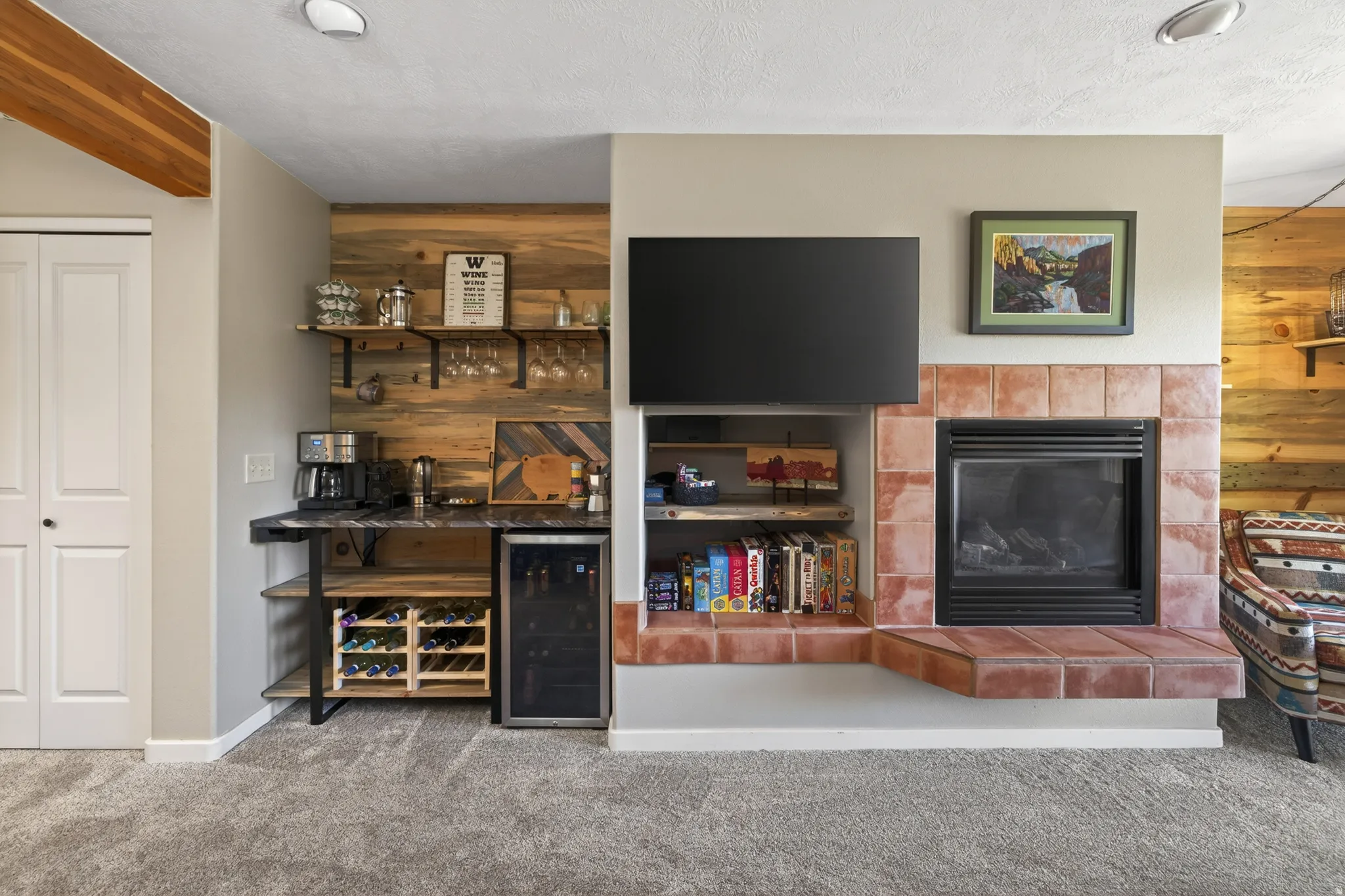 Integrated bar with wood-finish backsplash, custom shelving, a built-in wine rack, and a beverage cooler