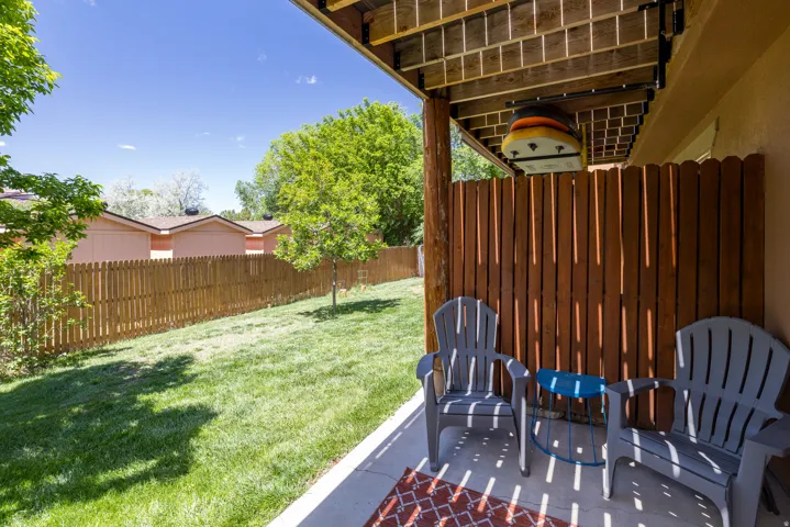 Private patio with concrete flooring, accented by a wood-slat privacy screen