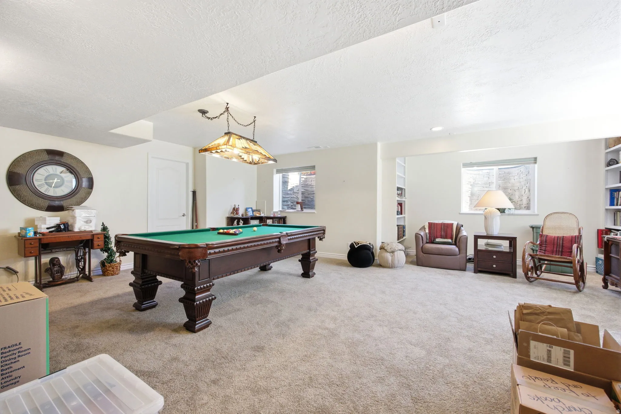 Spacious room featuring neutral carpet flooring and white walls