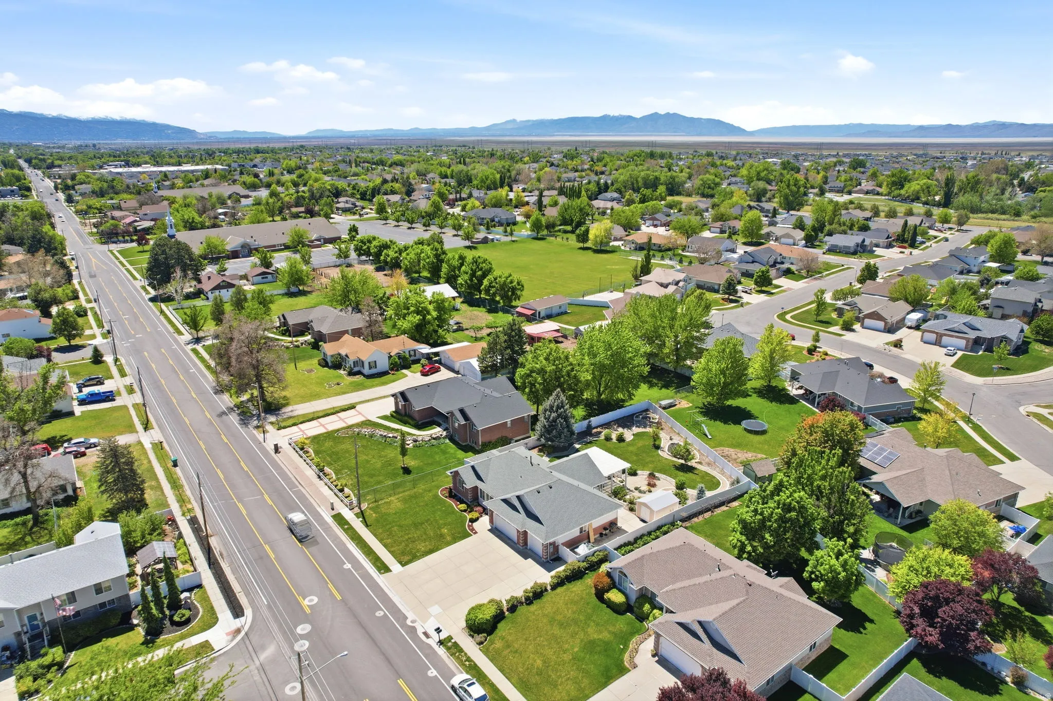 Expansive residential area featuring numerous single-family homes with lush green lawns and mature trees