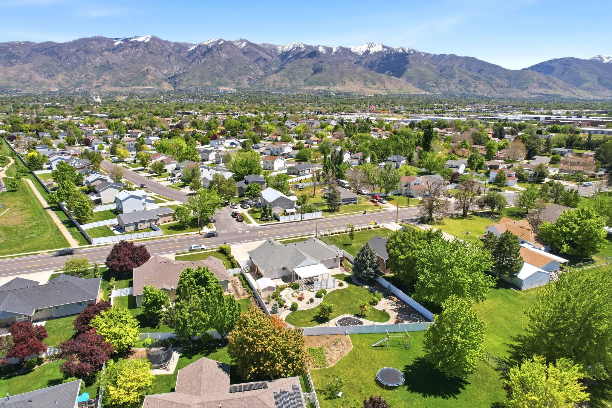Expansive residential neighborhood with mature trees and mountain backdrop