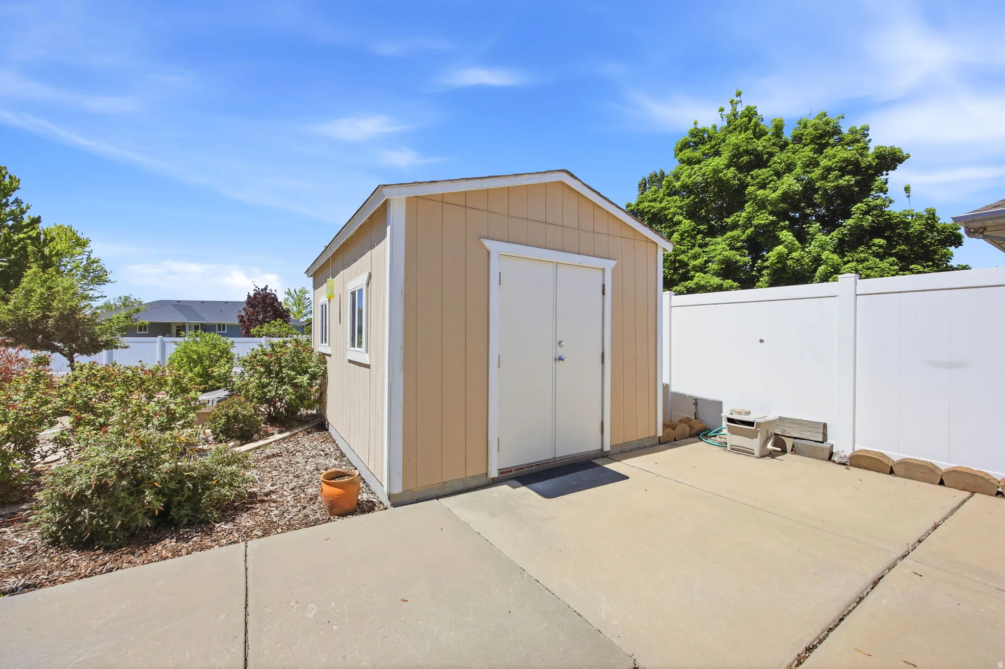 Freestanding storage shed with dual access doors and two side windows