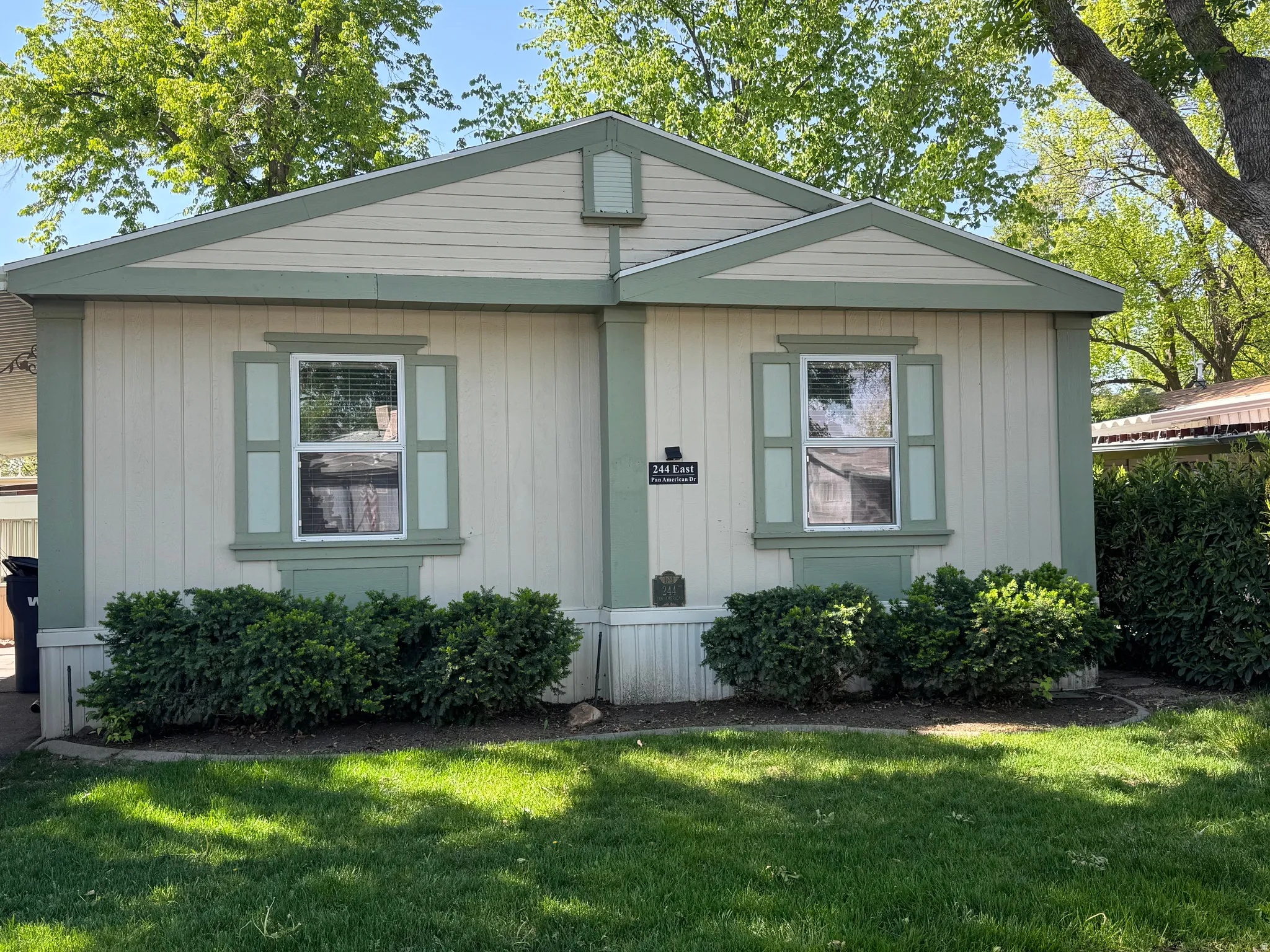 Single-story exterior with vertical siding and light green trim