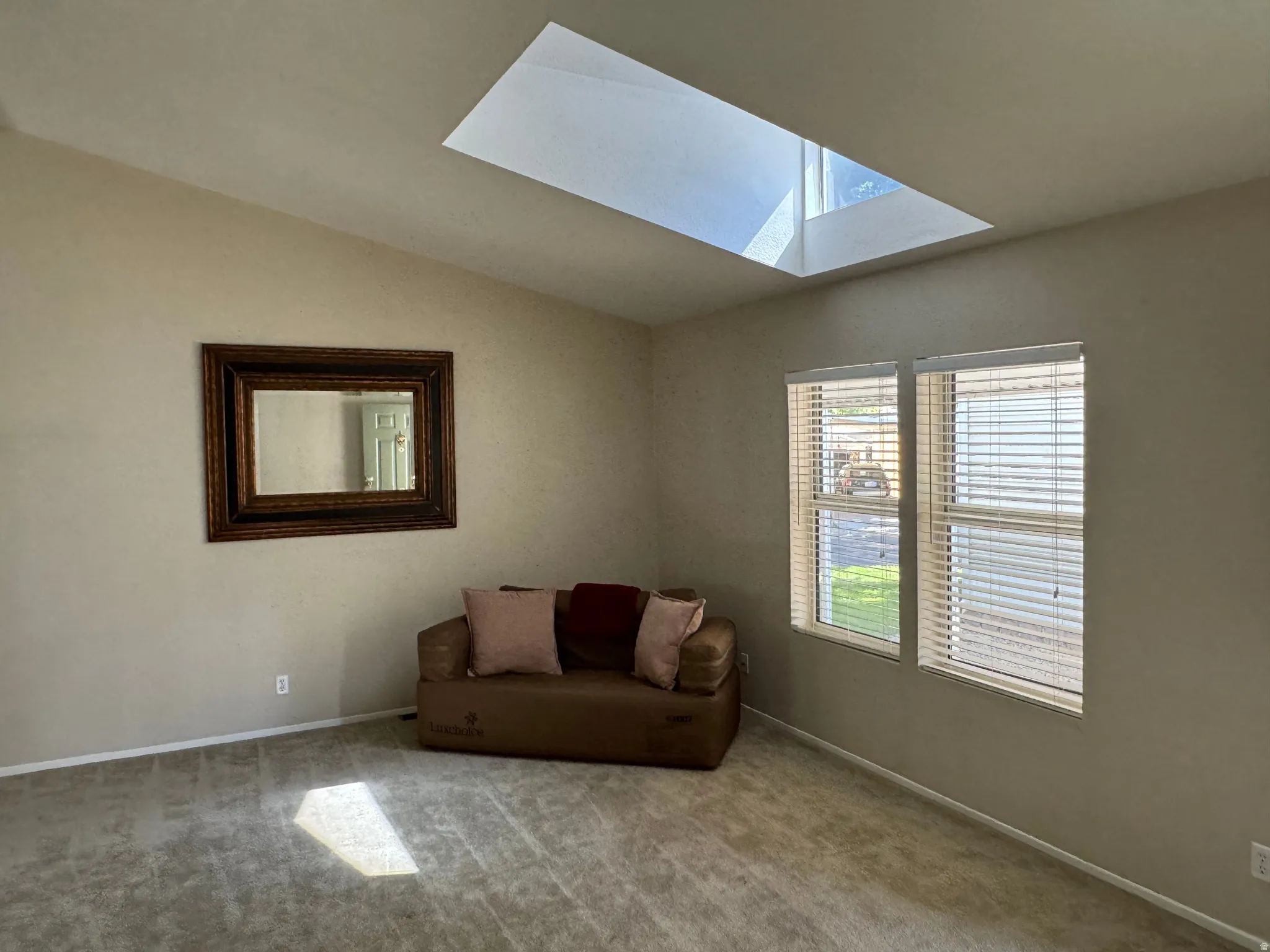 Vaulted ceiling featuring a large skylight