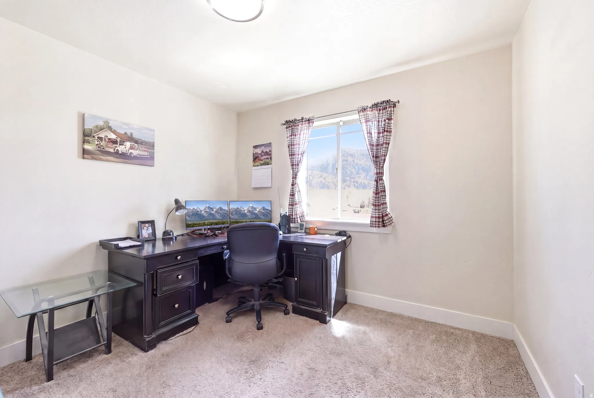 Neutral-toned room with carpet flooring and a double-pane window