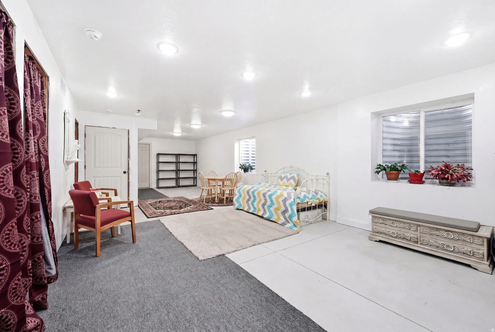 Spacious area featuring recessed lighting, a window with horizontal blinds, and a combination of carpet and hard surface flooring