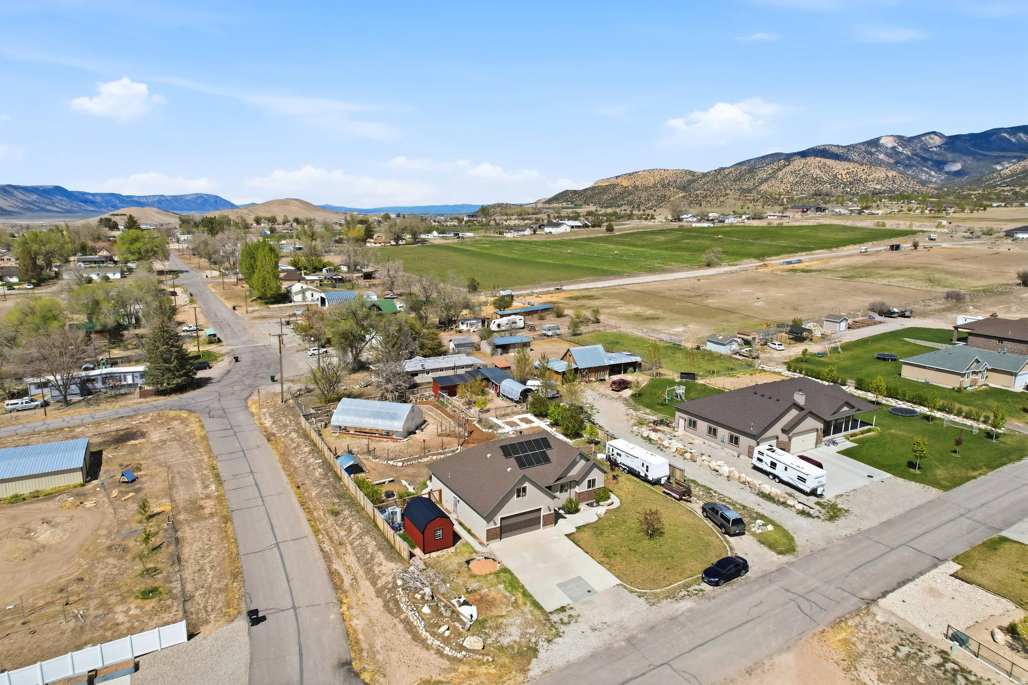 Ranch-style home featuring a brown roof, attached garage, solar panels.  Red shed is excluded, but negotiable.
