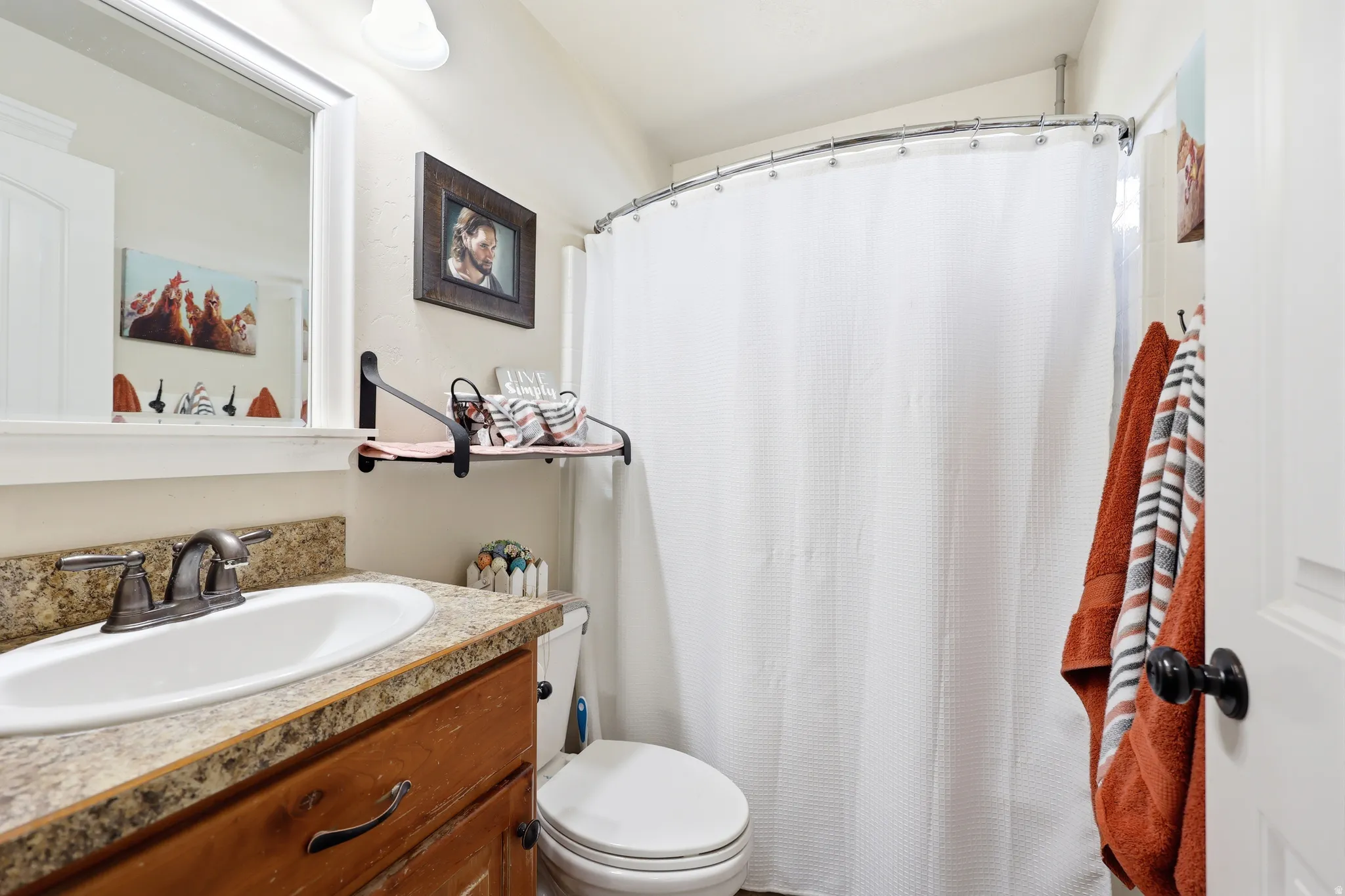 Bathroom vanity featuring a rectangular sink, speckled countertop, and dark wood-finish cabinetry