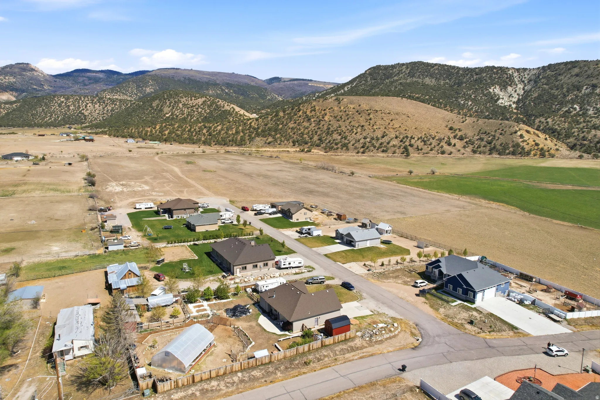 Residential community featuring varied home styles, mountain backdrops, and open fields.  Red shed is excluded, but negotiable.