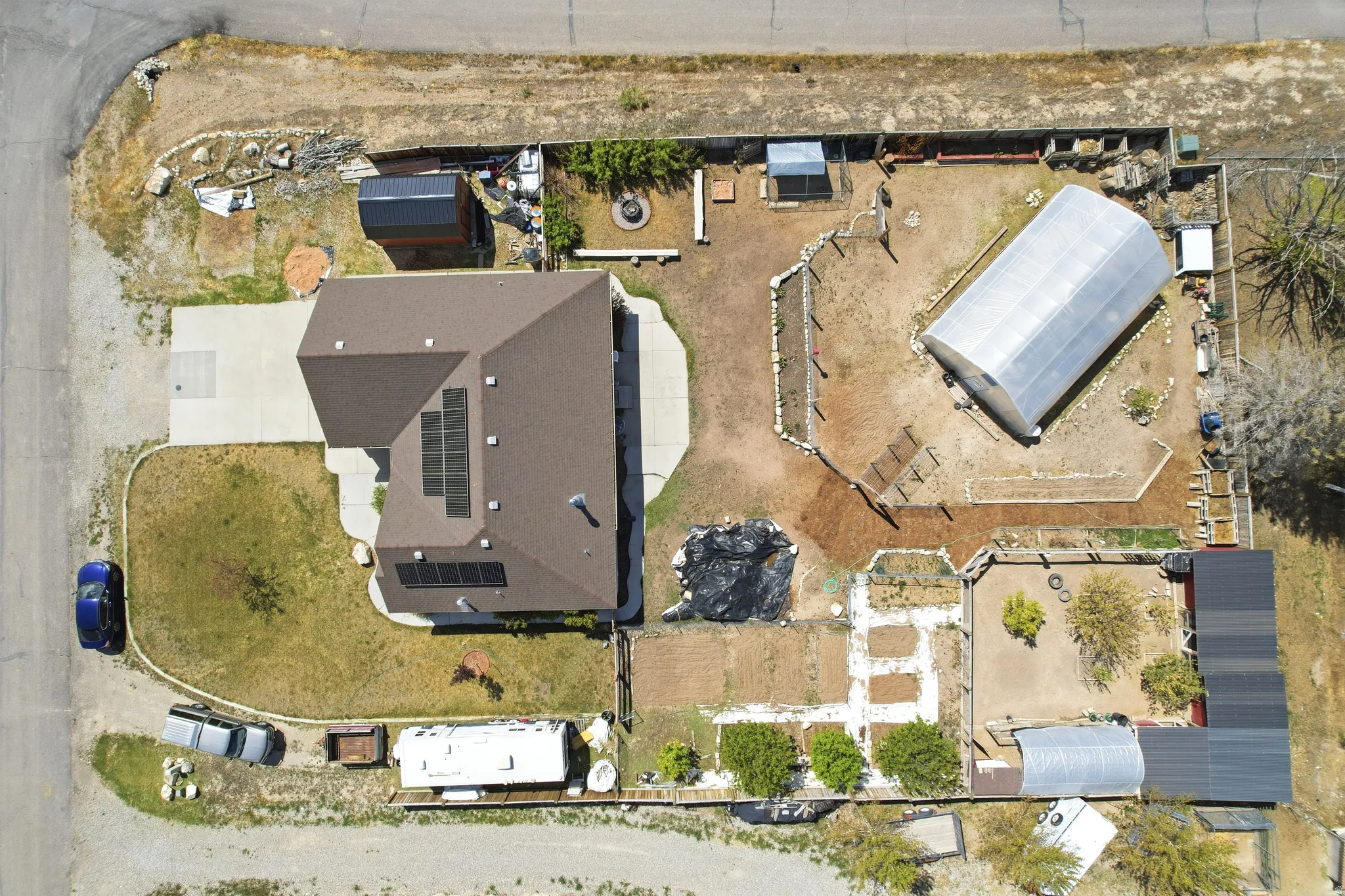 Single-story residence featuring a brown shingle roof with solar panels