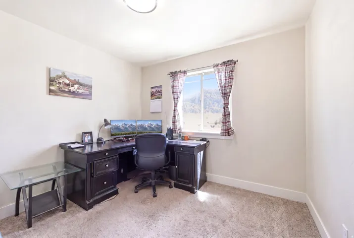 Neutral-toned room with carpet flooring and a double-pane window