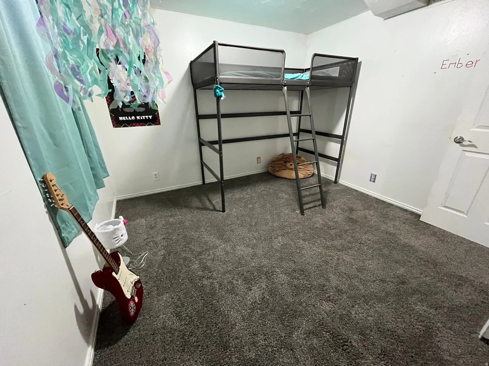 A cozy bedroom with plush carpet and a practical layout, ideal for everyday living or accommodating guests.