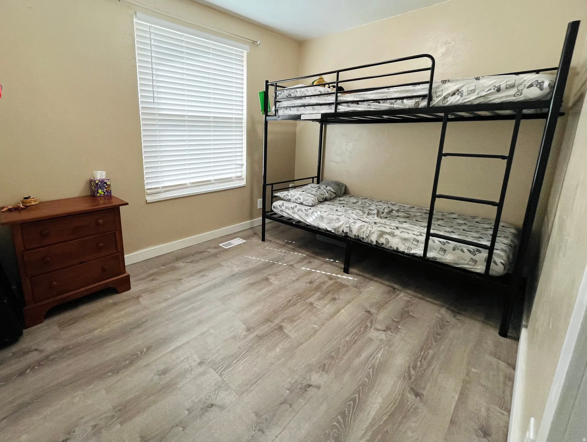 This bright bedroom features natural light and a comfortable layout, creating a peaceful place to unwind.