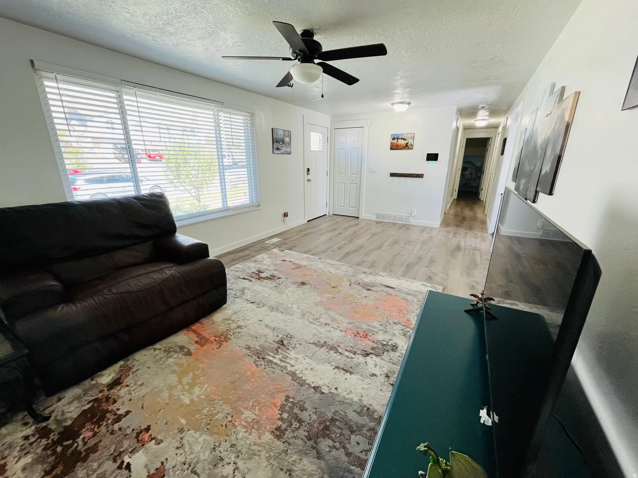 Living area featuring LVP flooring and abundant natural light.