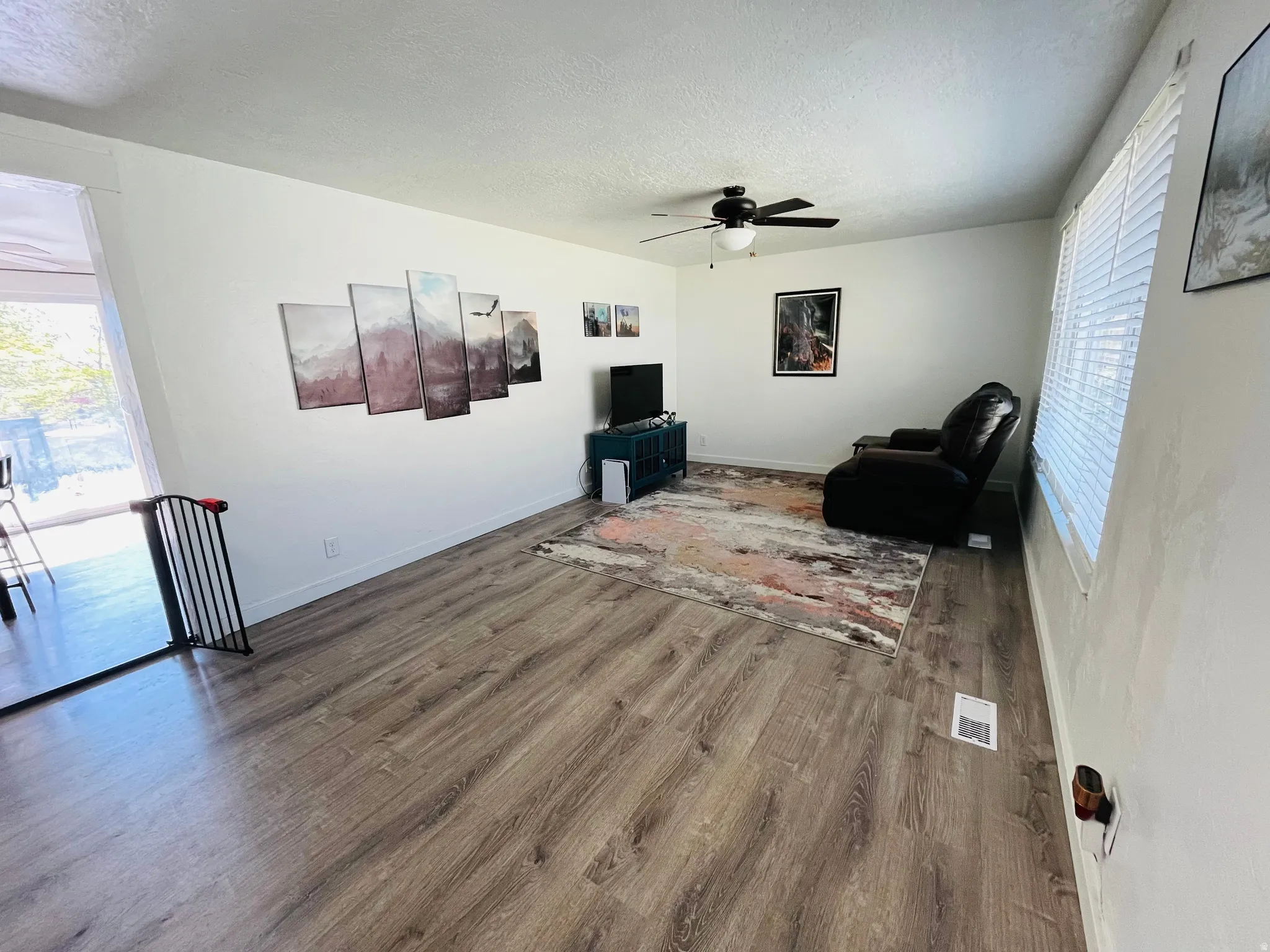 Living area featuring LVP flooring and abundant natural light.