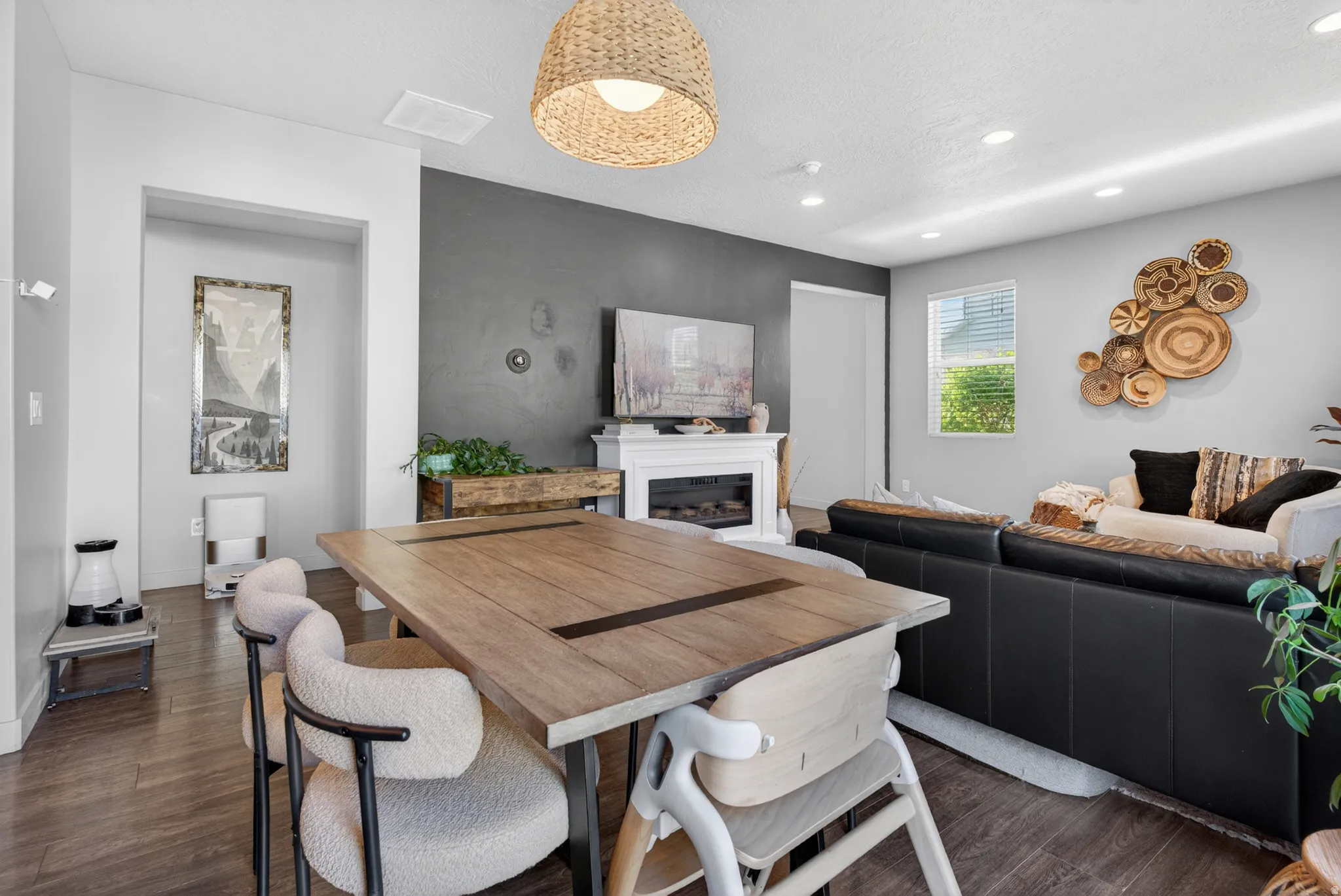 Open-concept living area with wood-finish flooring
