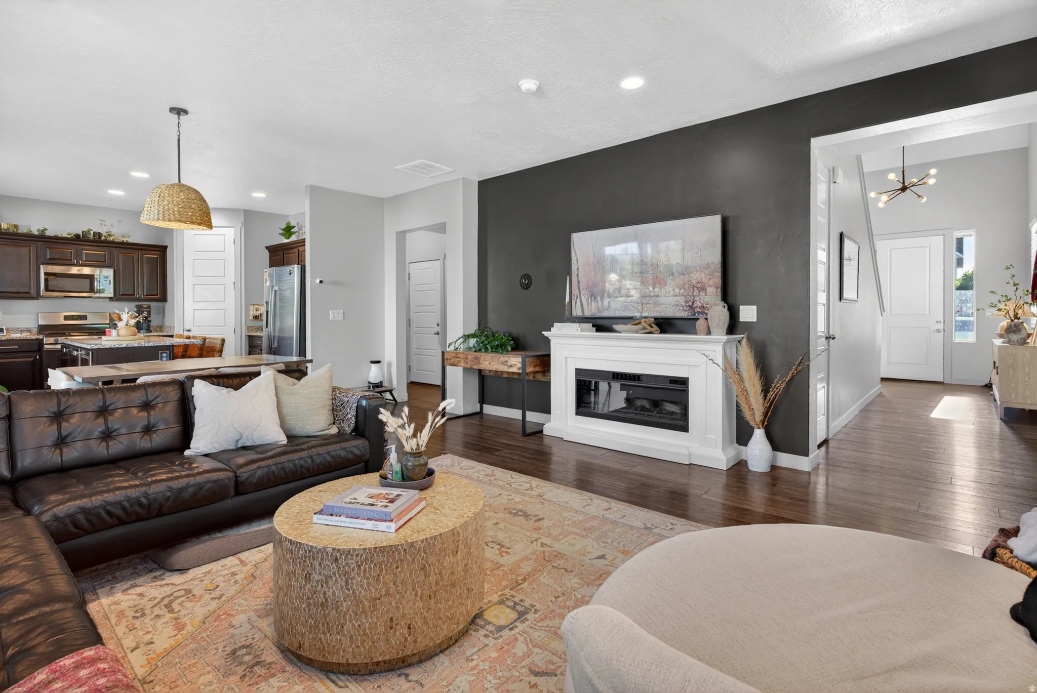 Open-concept living area featuring rich wood-finish flooring