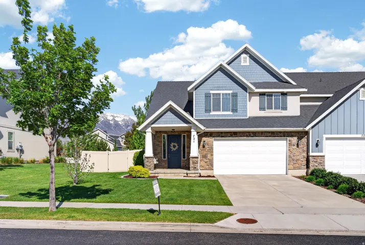 Stone and siding exterior with a two-car garage