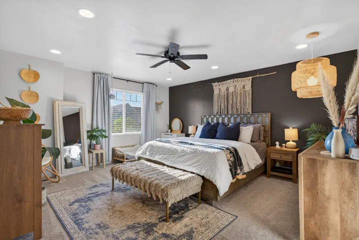 Spacious bedroom with an accent wall, window with blinds, recessed lighting, ceiling fan, and carpeted flooring