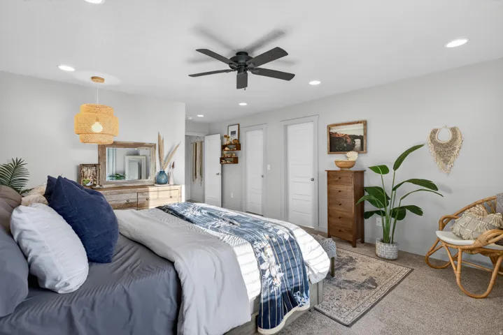 Bedroom featuring a ceiling fan with integrated lighting, recessed ceiling lights, and light gray wall paint