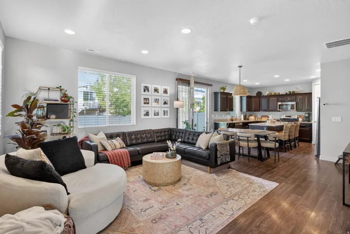 Open-concept living space featuring wood-finish flooring throughout