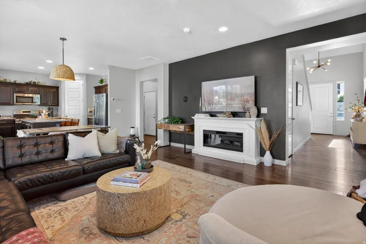 Open-concept living area featuring rich wood-finish flooring