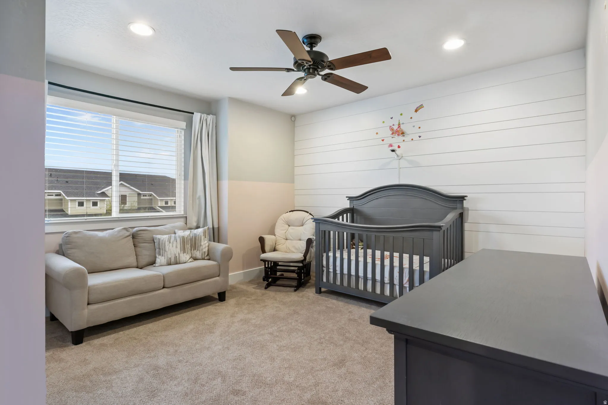 Carpeted room featuring a ceiling fan with integrated lighting, recessed lighting, and a large window with blinds