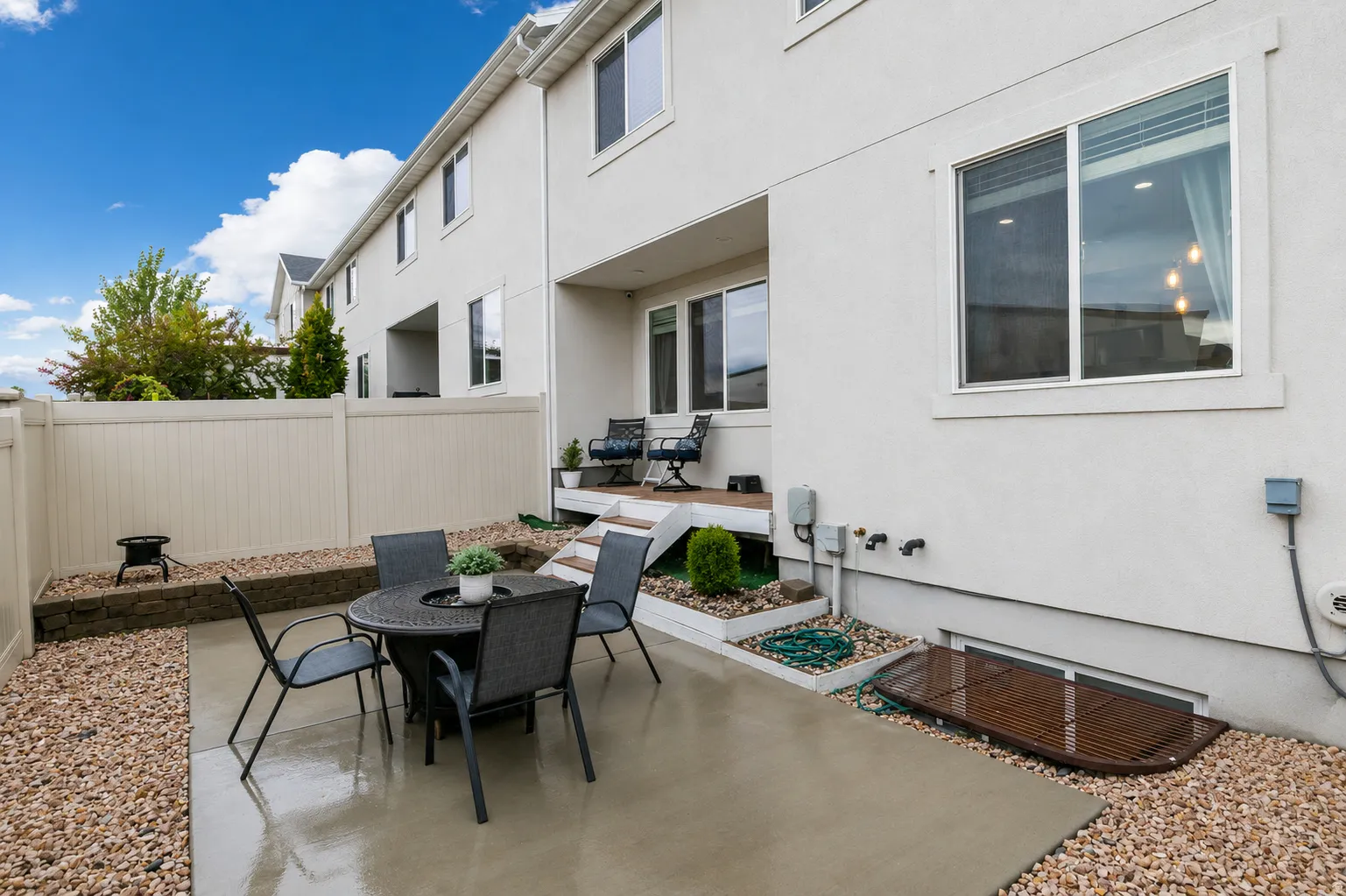 Private fenced patio featuring a concrete slab and decorative gravel landscaping