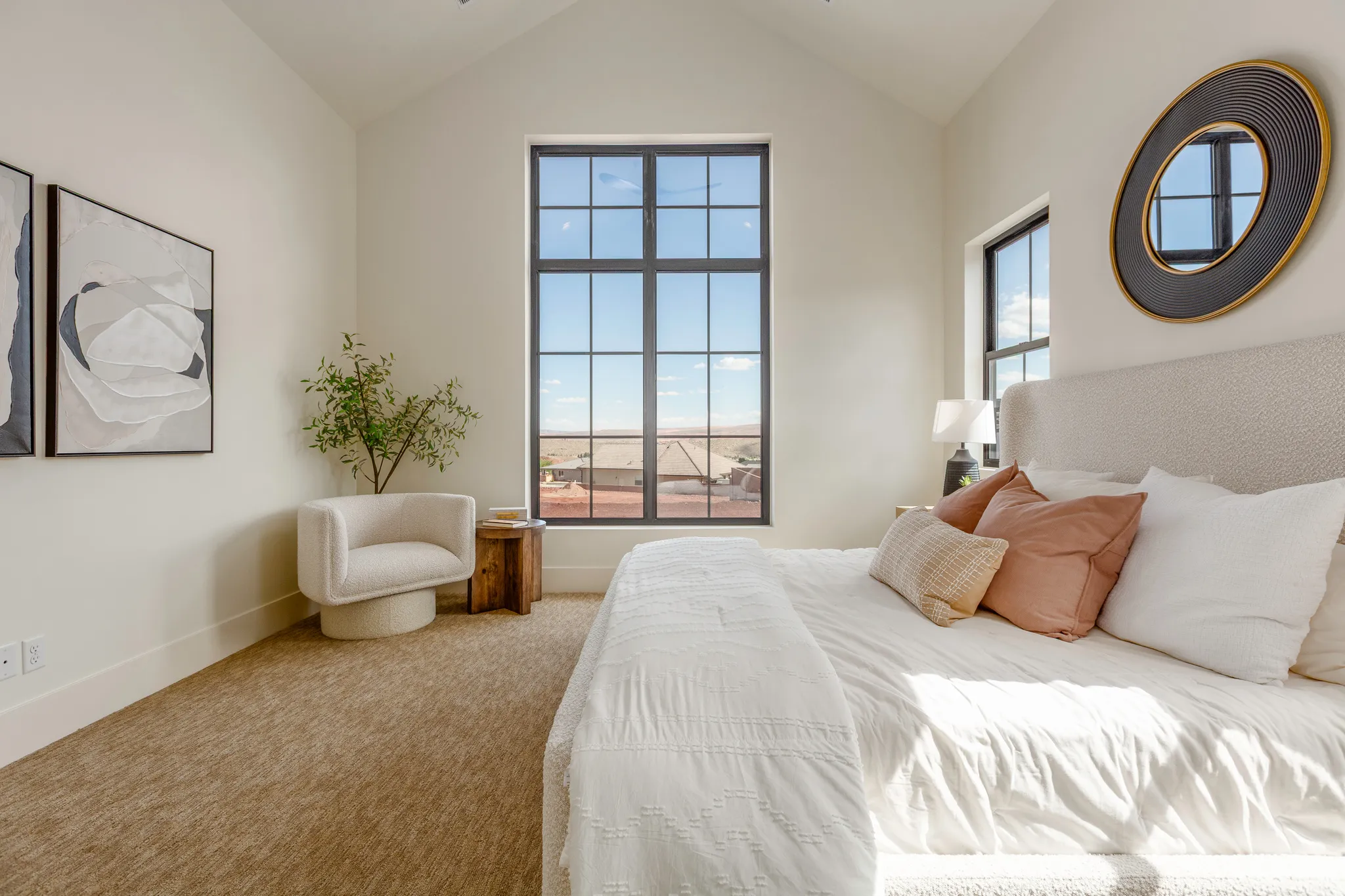 Room featuring a vaulted ceiling and a large grid-pattern window
