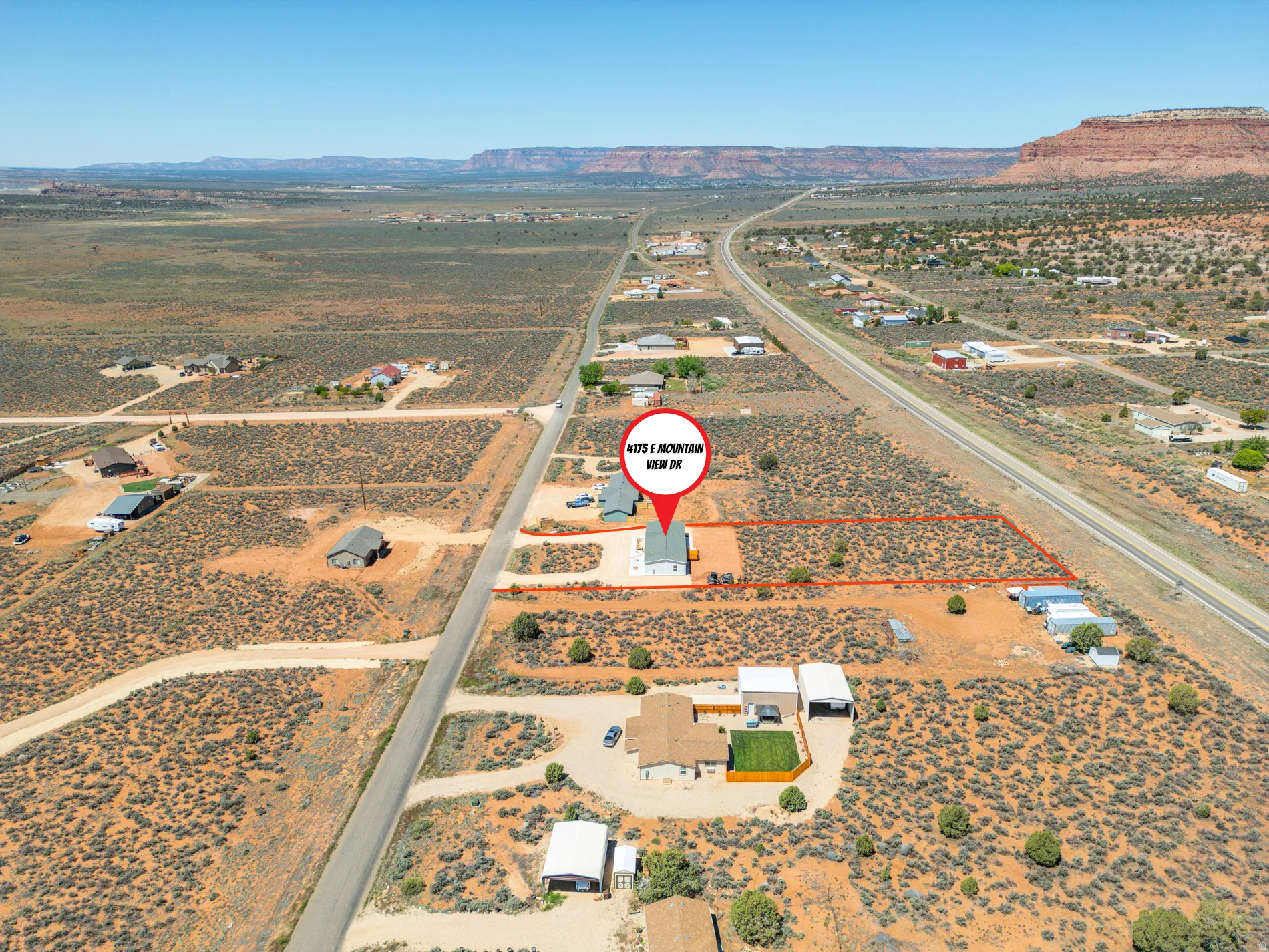 Expansive undeveloped land featuring a cleared section, flat terrain, and direct road frontage