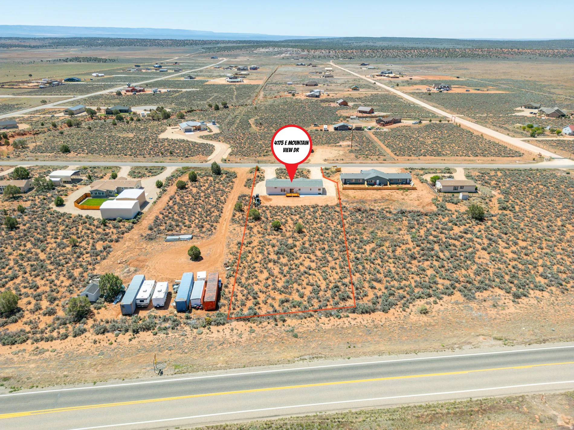 Expansive undeveloped land parcel featuring natural desert landscaping and direct road frontage