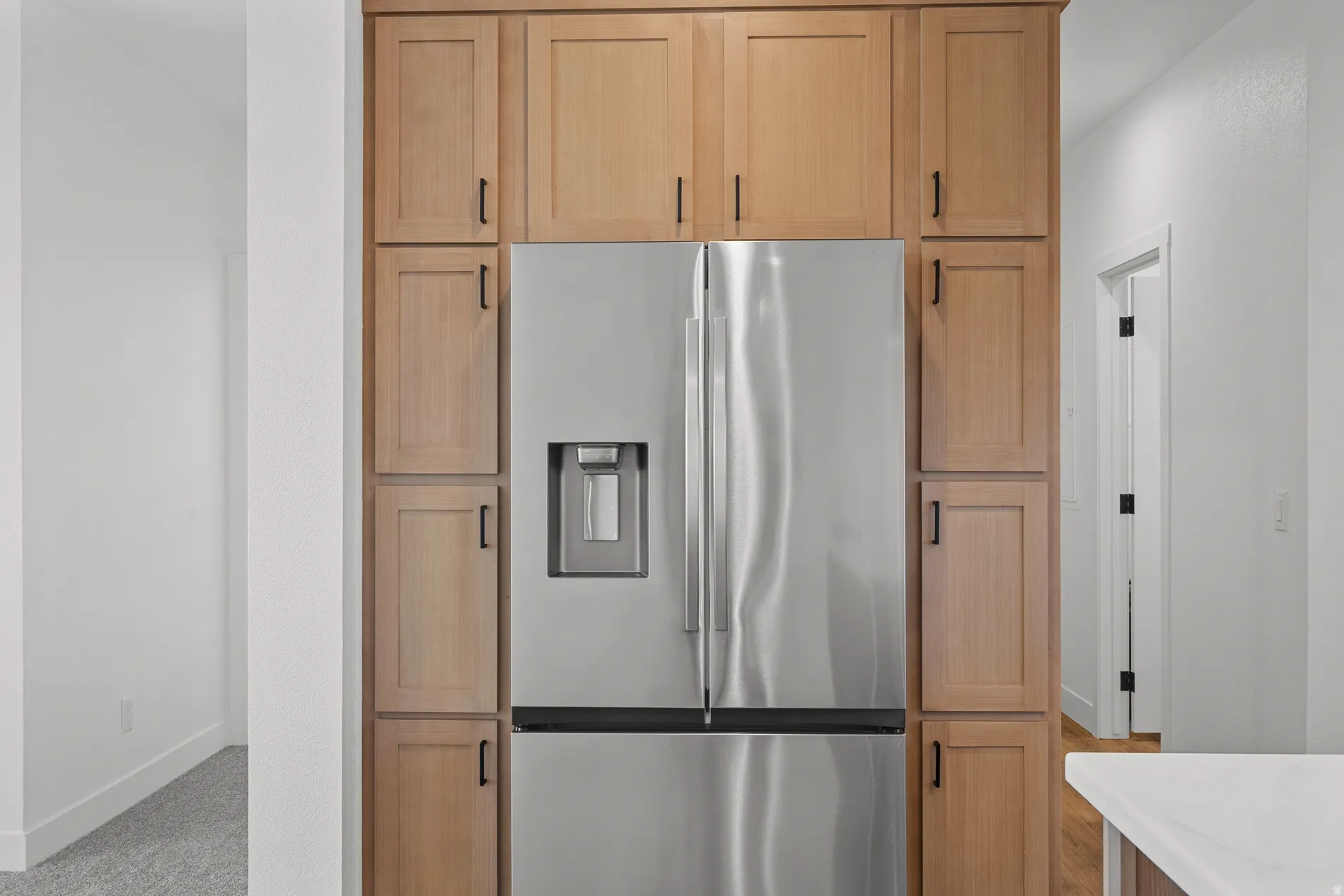 Integrated stainless steel French door refrigerator with exterior ice and water dispenser