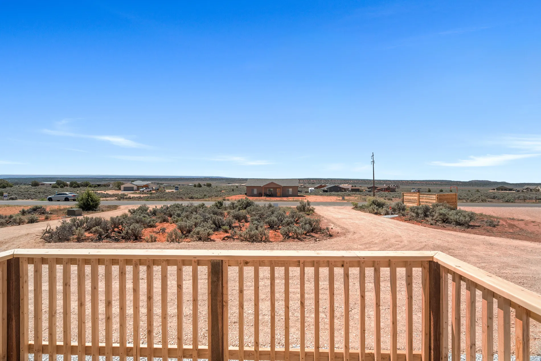 Expansive outdoor landscape with a light wood deck railing