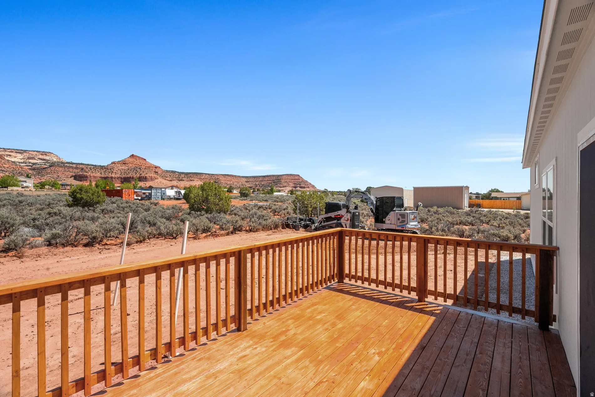 Expansive outdoor deck featuring wood-finish decking and railing